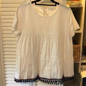 White shirt with blue and red trimming along the bottom! Size M